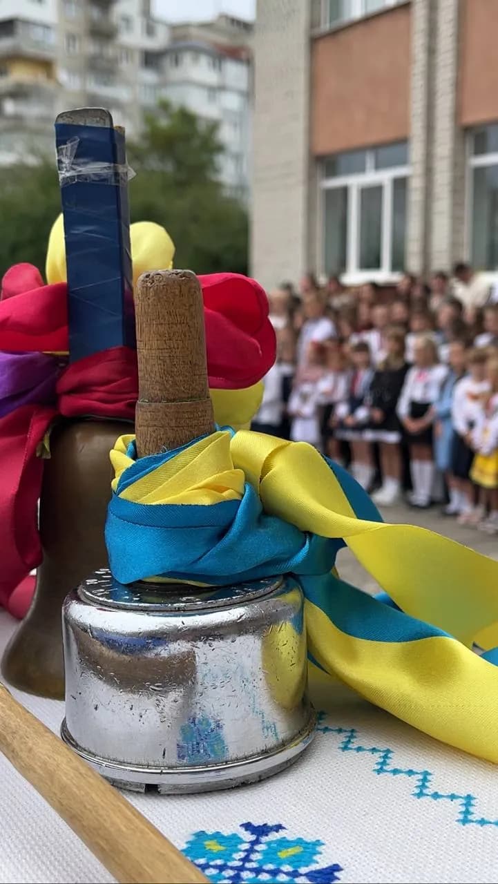 шкільний дзвоник із жовто-блакитною стрічкою