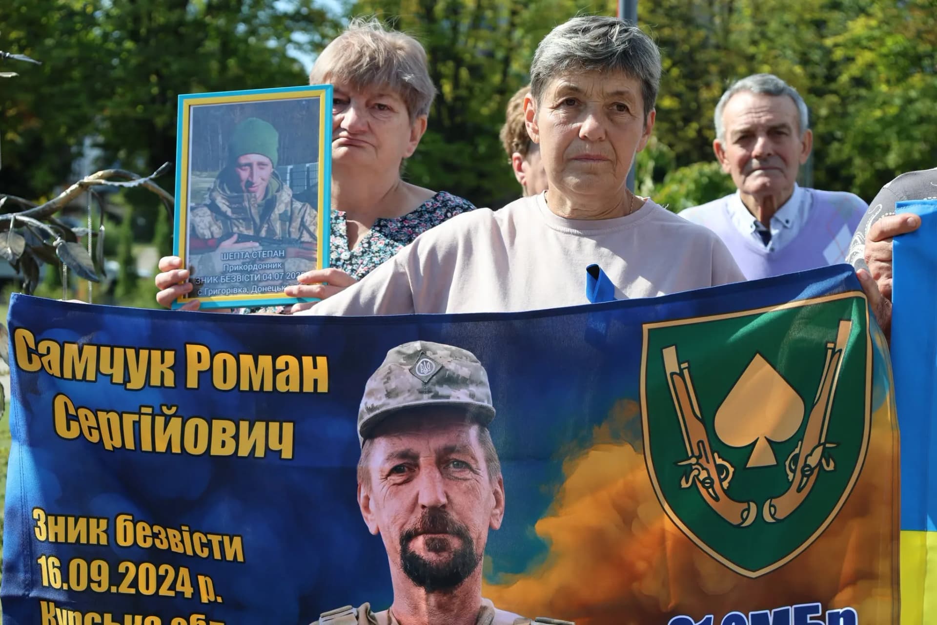 жінки з прапором, на якому портрет воіна